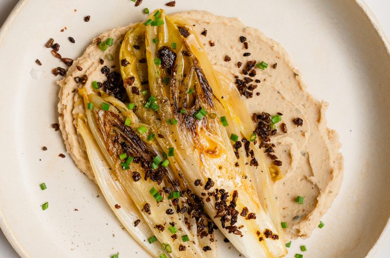 Gebratener Chicorée mit Pumpernickelknusper, weißem Bohnenpüree und Beurre Blanc